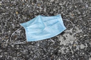 Discarded face mask lies on the ground. More than a year...