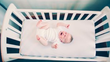 Crying baby in a crib