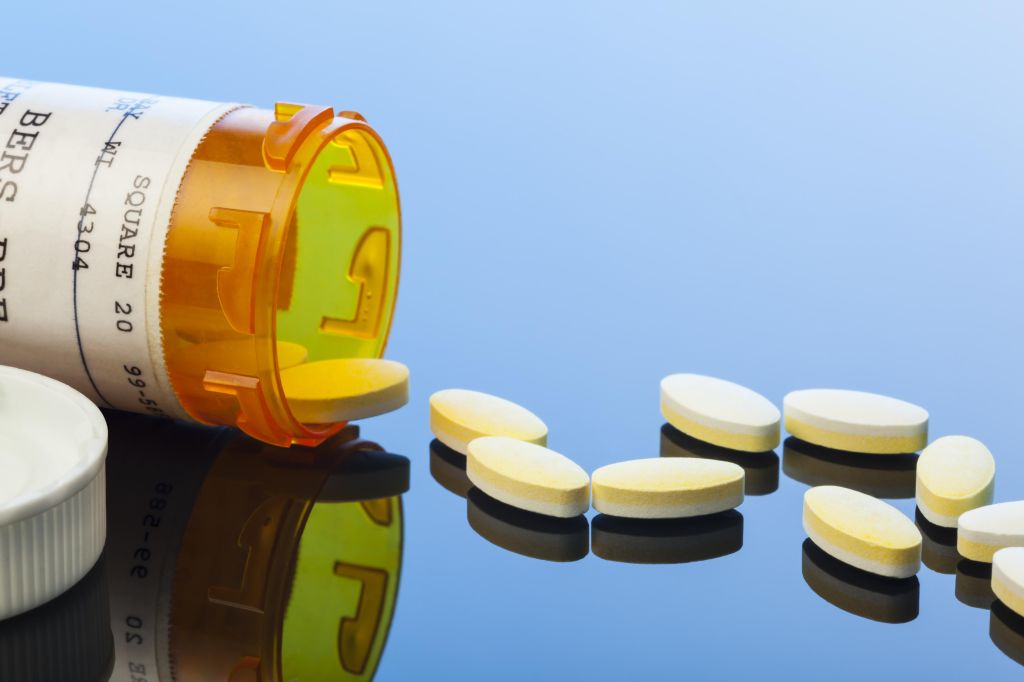 Prescription Drug Capsules Spilled on Reflective Surface