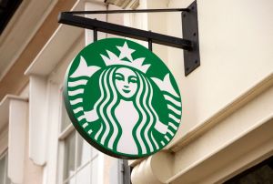 Starbucks sign outside High Street shop cafe, UK