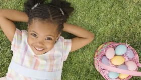 African girl laying next to Easter basket