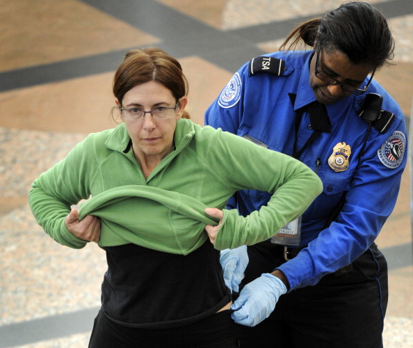 111710_PATDOWN_CFW- A Transportation Security Administration agent performs an enhanced pat down on a commuter at a security area at Denver International Airport in Denver, CO, November 17, 2010. (Craig F. Walker/ The Denver Post)