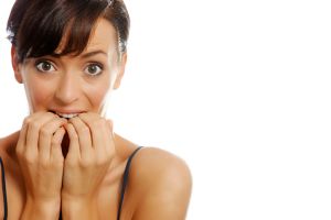 Young woman biting her nails in antiquation.