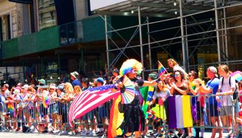 NYC Pride March 2022, Colorful marcher with Rainbow and American flags, Manhattan, New York City