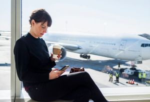 Woman using phone while sitting at airport