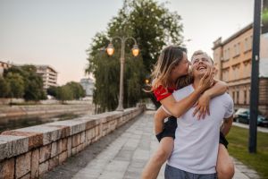 Loving boyfriend carrying his girlfriend on his back