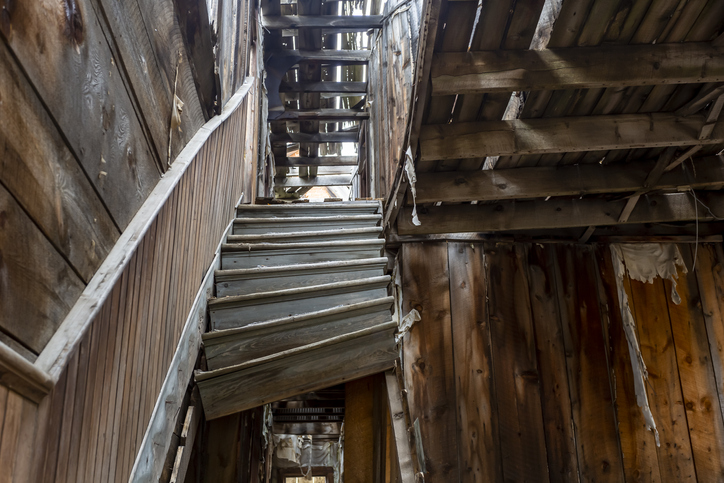 Broken staircase in an old building in a ghost town