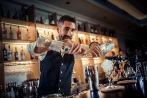 Bartender preparing cocktails and coffee