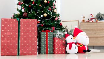 Beautiful Christmas gifts under Christmas tree at living room, Xmas and new year home decorations, festive tree decorated with decoration items, winter holiday traditional celebration