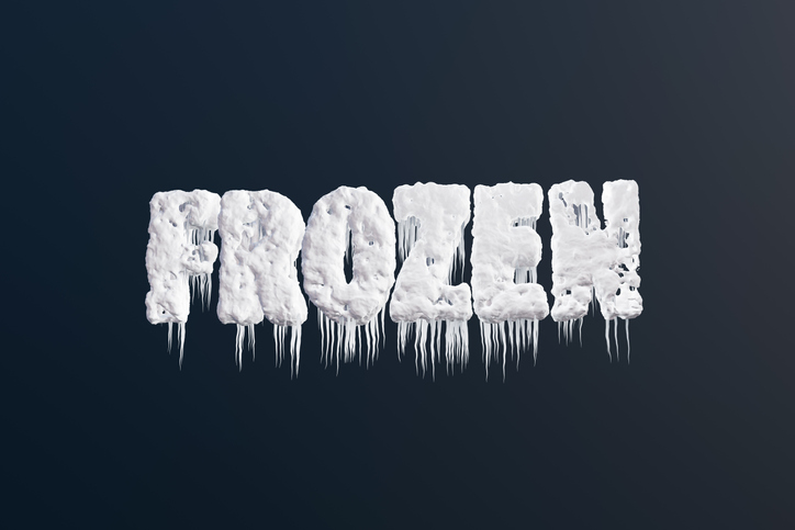 Alphabets FROZEN covered with snow, ice and icicles on dark background. Illustration of the concept of blizzard, winter, coldness and snowfall