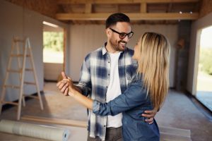 Happy couple enjoying in dance at construction site.