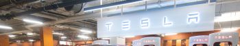 A Tesla car seen charging at the Tesla supercharger station...