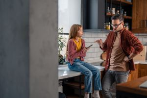 Angry strict father scolding stubborn daughter. Family conflicts and punishment concept