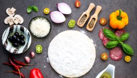 The ingredients for homemade pizza on dark stone background,Romania