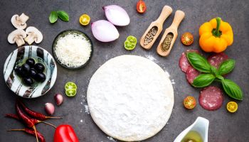 The ingredients for homemade pizza on dark stone background,Romania