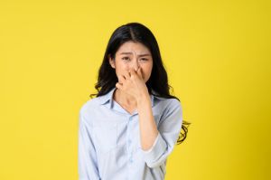 portrait of beautiful asian girl posing on yellow background