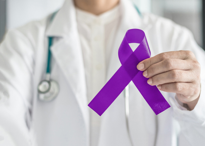 Plum purple ribbon for raising awareness on Alzheimer's disease, breastfeeding, eating disorder, national family caregivers month and epilepsy illness with bow in doctor's hand support