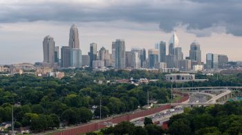 Downtown Charlotte, North Carolina, USA, distant view from the highway Interstate 77 on a rainy summer evening.