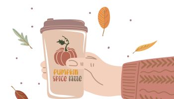 Human hand holding cup of hot drink. Pumpkin spice latte with whipped cream and cinnamon