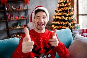 Photo of funky excited person eye wink blink point fingers camera you festive magic illumination flat indoors