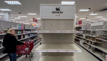 A shopper looks over empty shelves once stocked with Stanley insulated steel tumblers...
