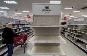 A shopper looks over empty shelves once stocked with Stanley insulated steel tumblers...
