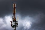 Mobile phone transmitter mast with dark clouds in the sky