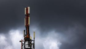 Mobile phone transmitter mast with dark clouds in the sky