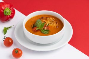 Tomato soup with fresh parsley garnish in a bowl.