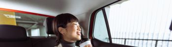 A mid adult Japanese woman enjoying a car ride