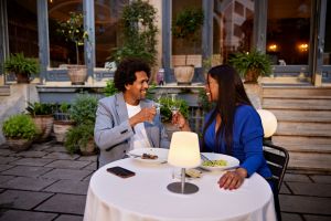 Celebratory toast during restaurant dinner date