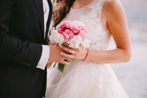 Midsection Of Newlywed Couple Holding Hands