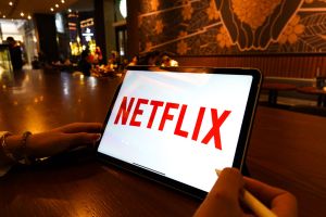 In this photo illustration, a Netflix logo is displayed on...