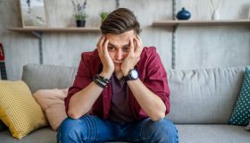 Young worried man at home