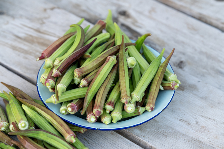 Fresh organic Okra Pods in a Plate on Wooden Table
